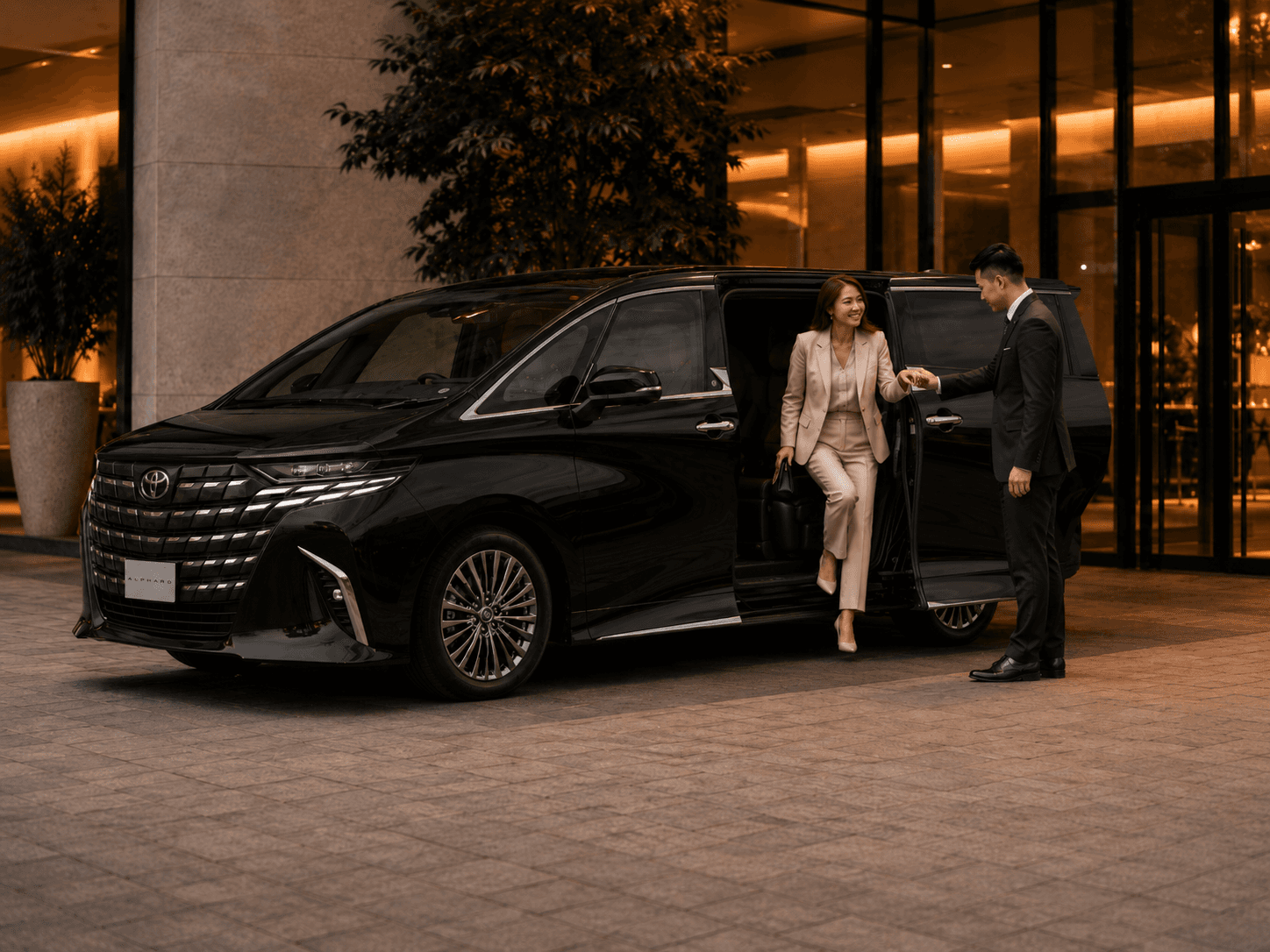 A KOI chauffeur opening the door of a premium MPV for a customer